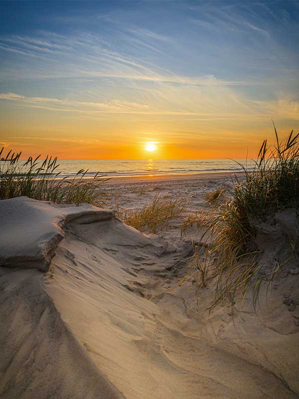 Sunset over the West Michigan lakeshore, representing the accessibility of telehealth and in person therapy services from Holland Psychological Services