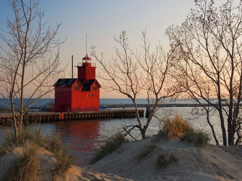 A peaceful lakeshore lighthouse scene, representing the mental wellness with a therapist in Holland MI
